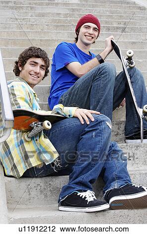 Two young skateboarders sitting on stairs View Large Photo Image Stock Image - Two young skateboarders sitting on stairs. Fotosearch