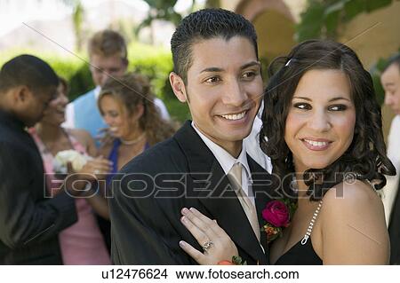 Well-dressed teenage couple embracing outside school dance View Large Photo Image Picture - Well-dressed teenage couple embracing outside school dance. Fotosearch