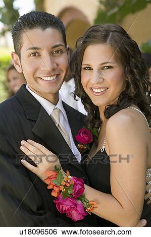 Well-dressed teenage couple embracing outside school dance, portrait View Large Photo Image Stock Photograph - Well-dressed teenage couple embracing outside school dance, portrait. Fotosearch