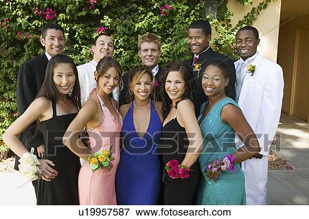 Stock Photo - Well-dressed teenage couple outside, portrait. Fotosearch