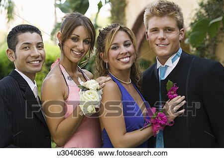 Stock Photograph - Well-dressed teenage couples outside, portrait. Fotosearch