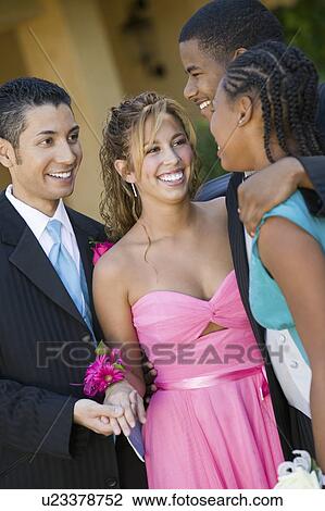 Stock Image - Well-dressed teenage couples talking outside. Fotosearch