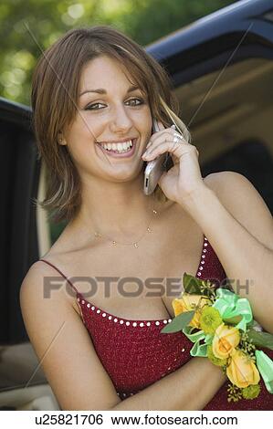 Stock Photograph - Well-dressed teenage girl using cell phone outside. Fotosearch