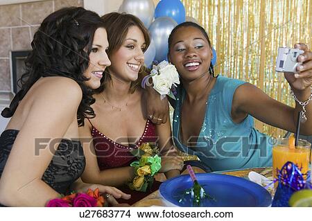 Well-dressed teenage girls taking picture at school dance View Large Photo Image Picture - Well-dressed teenage girls taking picture at school dance. Fotosearch