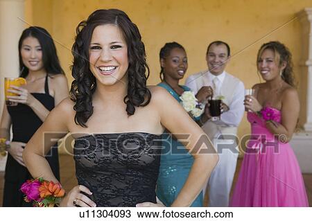 Stock Image - Well-dressed teenagers at school dance. Fotosearch
