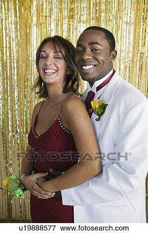 Stock Photo - Well-dressed teenagers at school dance, portrait. Fotosearch