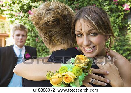 Well-dressed teenagers hugging outside View Large Photo Image Stock Image - Well-dressed teenagers hugging outside. Fotosearch