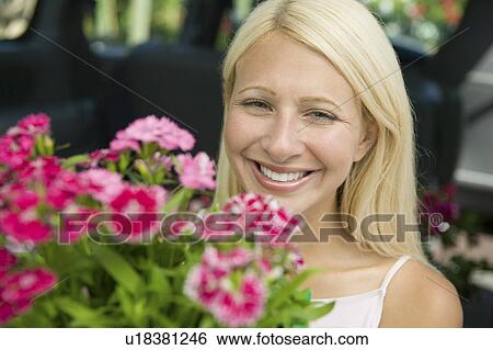 Stock Photograph - Woman Holding Flowers, portrait. Fotosearch
