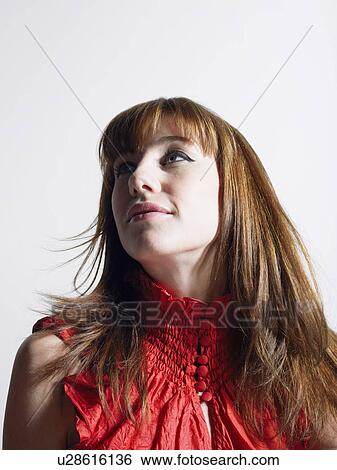 Woman in red top in studio, head and shoulders View Large Photo Image Stock Photograph - Woman in red top in studio, head and shoulders. Fotosearch