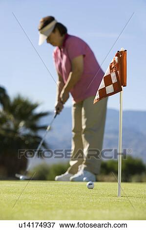 Stock Photo - Woman playing golf. Fotosearch