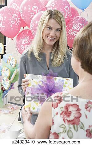 Woman Receiving a Gift at a Baby Shower View Large Photo Image Stock Image - Woman Receiving a Gift at a Baby Shower. Fotosearch