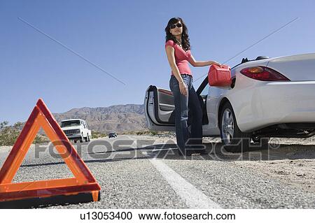 Stock Image - Woman refuelling car. Fotosearch
