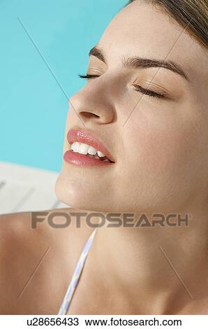 Woman Relaxing by pool, close up of head View Large Photo Image Stock Image - Woman Relaxing by pool, close up of head. Fotosearch