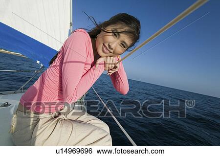 Woman relaxing on sailboat, (portrait) View Large Photo Image Stock Photograph - Woman relaxing on sailboat, (portrait). Fotosearch
