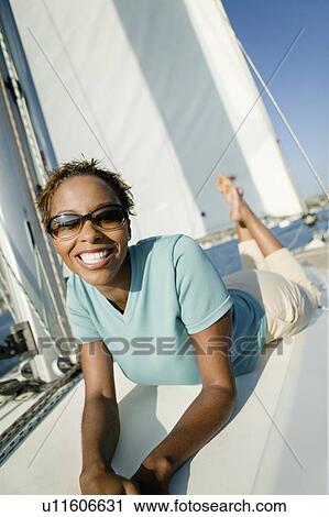 Woman relaxing on yacht, (portrait) View Large Photo Image Stock Image - Woman relaxing on yacht, (portrait). Fotosearch