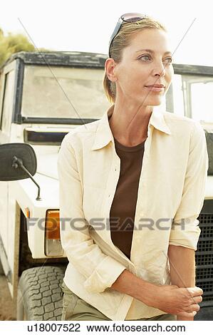 Woman standing in front of four wheel drive car, outdoors View Large Photo Image Stock Image - Woman standing in front of four wheel drive car, outdoors. Fotosearch