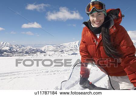 Woman Standing on snowmobile in snow, half length View Large Photo Image Picture - Woman Standing on snowmobile in snow, half length. Fotosearch