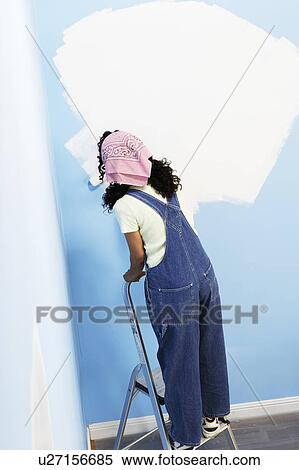 Woman standing on stepladder painting interior wall, back view, elevated view View Large Photo Image Stock Photography - Woman standing on stepladder painting interior wall, back view, elevated view. Fotosearch