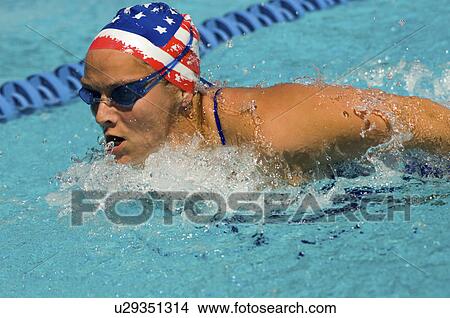 Woman swimming butterfly stroke, (close-up) View Large Photo Image Picture - Woman swimming butterfly stroke, (close-up). Fotosearch