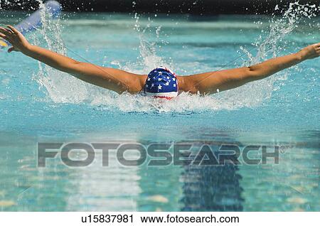 Stock Image - Woman swimming butterfly stroke. Fotosearch