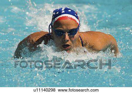 Stock Photo - Woman swimming butterfly stroke. Fotosearch