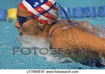 Woman swimming butterfly stroke, (close-up) View Large Photo Image Stock Photo - Woman swimming butterfly stroke, (close-up). Fotosearch