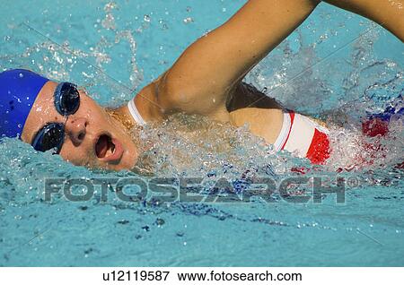 Stock Photo - Woman swimming in pool, (close-up). Fotosearch