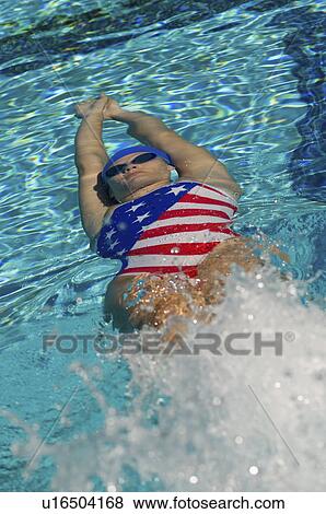 Stock Photo - Woman swimming underwater. Fotosearch