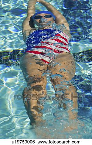 Stock Photograph - Woman swimming underwater. Fotosearch
