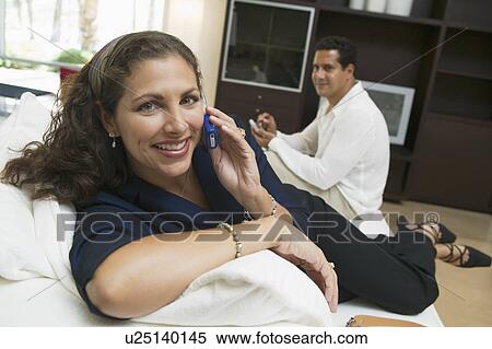Woman Using Cell Phone on Sofa, portrait, close up View Large Photo Image Stock Photography - Woman Using Cell Phone on Sofa, portrait, close up. Fotosearch
