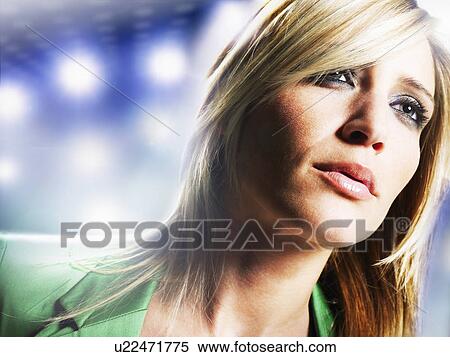 Stock Photography - Woman with blonde hair in front of spot lights. Fotosearch