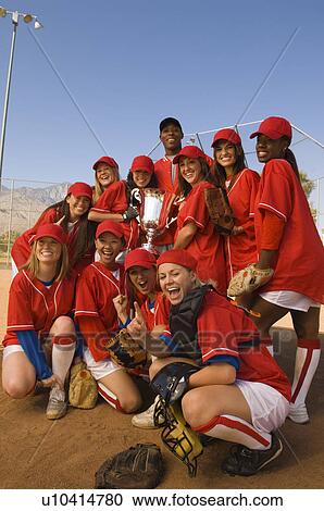 Stock Image - Women's softball team with trophy, portrait. Fotosearch