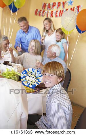 Stock Image - Young boy smiling, Family Having a retirement Party. Fotosearch