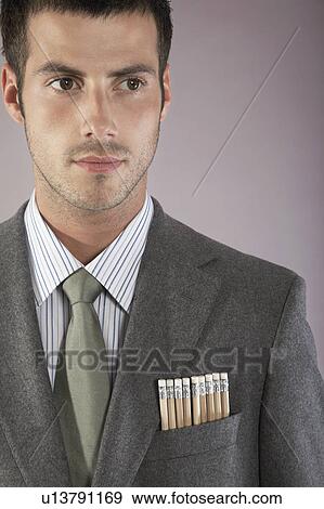 Stock Photo - Young businessman with pencils in pocket, portrait. Fotosearch