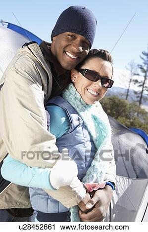 Stock Image - Young couple at campsite.. Fotosearch