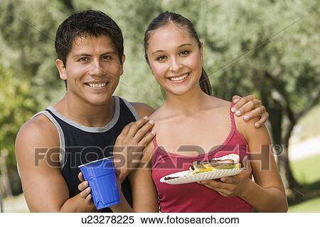 Young couple at picnic, front view. View Large Photo Image Stock Photography - Young couple at picnic, front view.. Fotosearch