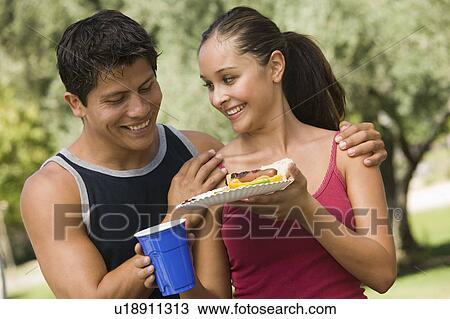 Young couple at picnic. View Large Photo Image Stock Image - Young couple at picnic.. Fotosearch