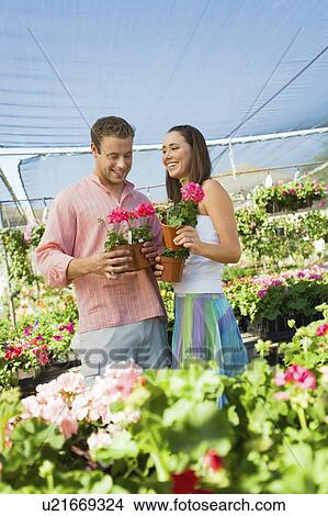 Young couple choosing potted flowers in garden centre View Large Photo Image Picture - Young couple choosing potted flowers in garden centre. Fotosearch