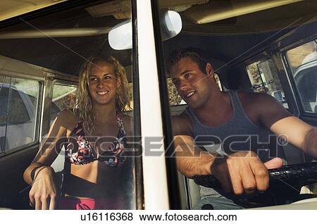 Stock Photo - Young couple driving van. Fotosearch