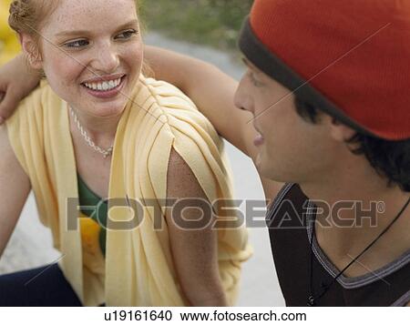Stock Image - Young couple embracing outdoors. Fotosearch