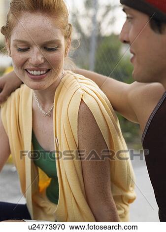 Stock Image - Young couple embracing outdoors. Fotosearch