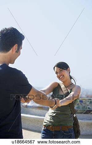 Young couple holding hands, portrait View Large Photo Image Stock Photo - Young couple holding hands, portrait. Fotosearch