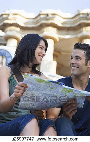 Young couple holding map, portrait View Large Photo Image Stock Photo - Young couple holding map, portrait. Fotosearch