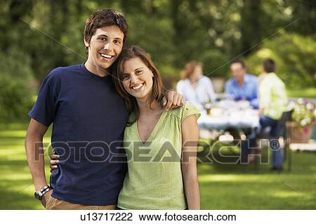 Young Couple in back yard, portrait View Large Photo Image Stock Image - Young Couple in back yard, portrait. Fotosearch