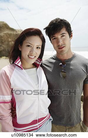 Young couple on beach, portrait View Large Photo Image Picture - Young couple on beach, portrait. Fotosearch