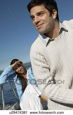Young couple on sailboat, (close-up) View Large Photo Image Stock Image - Young couple on sailboat, (close-up). Fotosearch