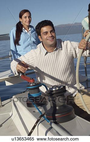 Stock Photography - Young couple on sailboat. Fotosearch