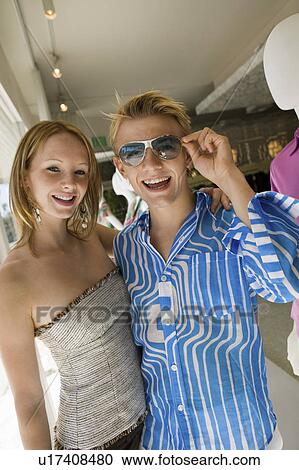 Young Couple Shopping in clothing store Together, portrait View Large Photo Image Stock Image - Young Couple Shopping in clothing store Together, portrait. Fotosearch