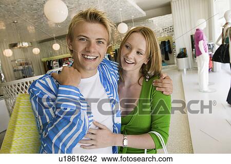 Stock Image - Young Couple Shopping in clothing store Together, portrait. Fotosearch
