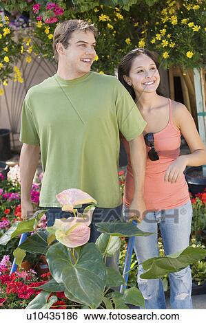 Young couple with wheelbarrow with plants in garden View Large Photo Image Stock Photograph - Young couple with wheelbarrow with plants in garden. Fotosearch